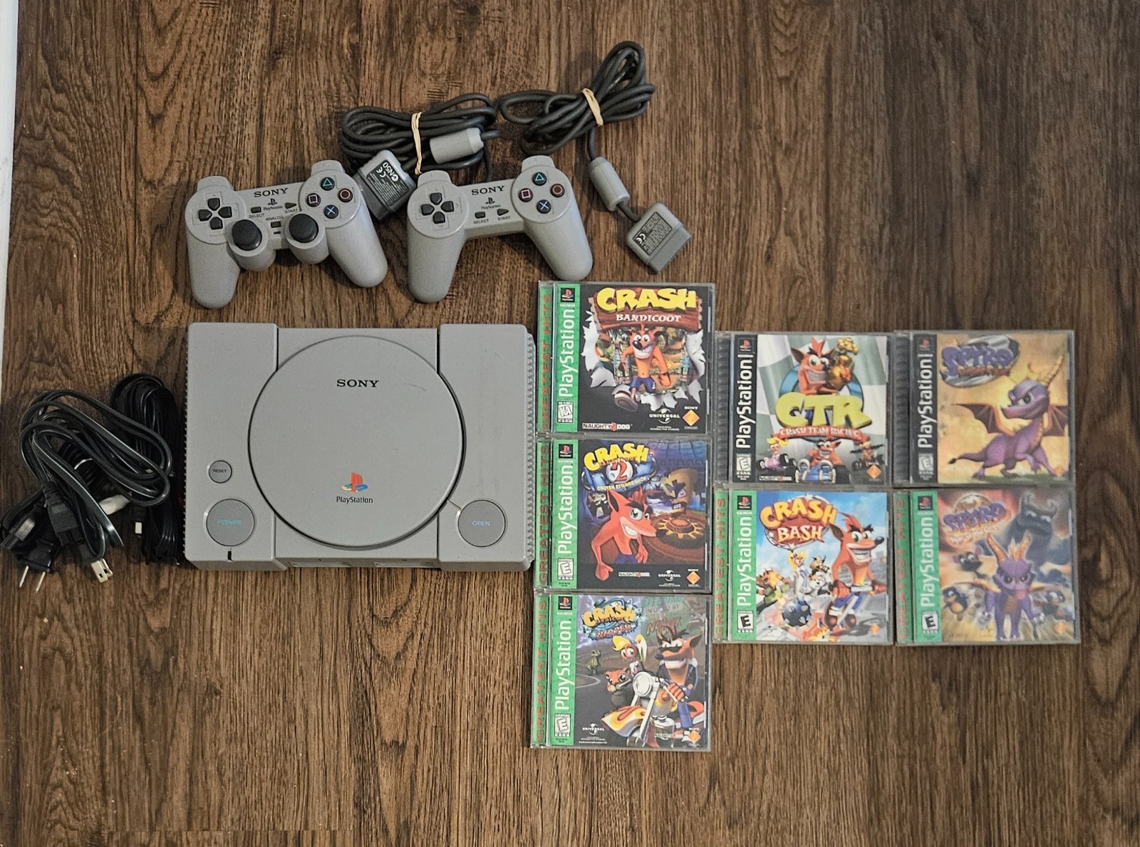 Sony PlayStation 1 with Cables, Controllers, Crash Bandicoot and Spyro Games