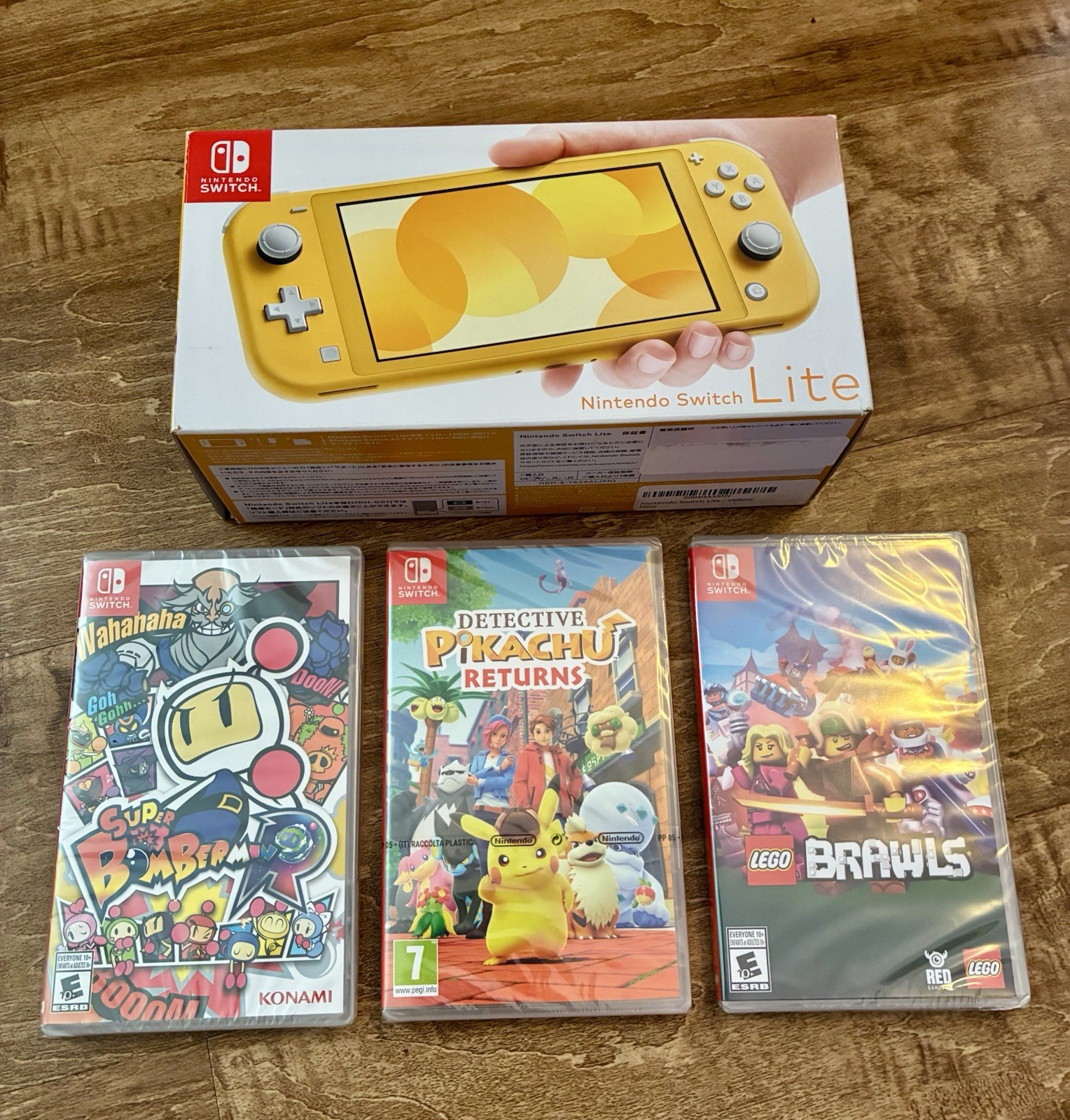 BRAND NEW Nintendo Switch Lite Yellow 32gb With 3 Sealed Games Pikachu Lego Bomb