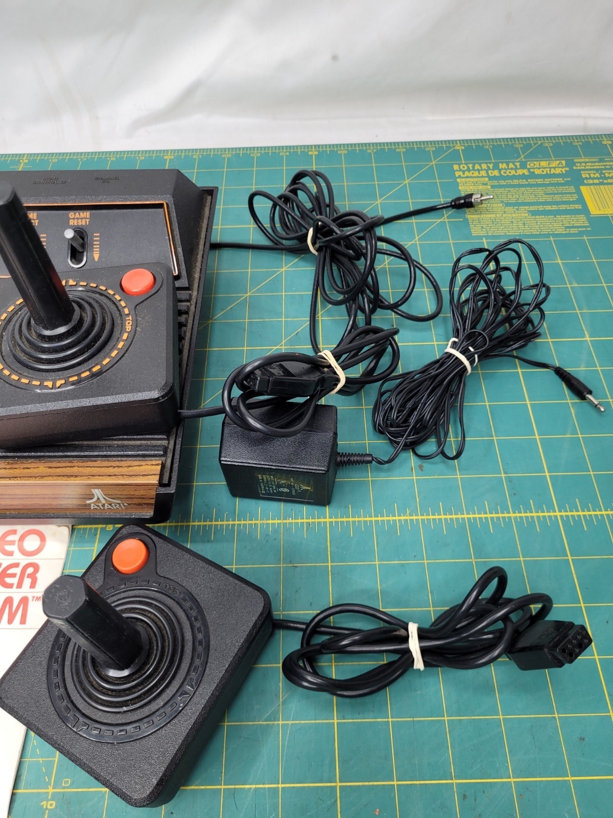 Atari 2600 console With Cords And 4 Joystick Controllers Powers On Needs Work