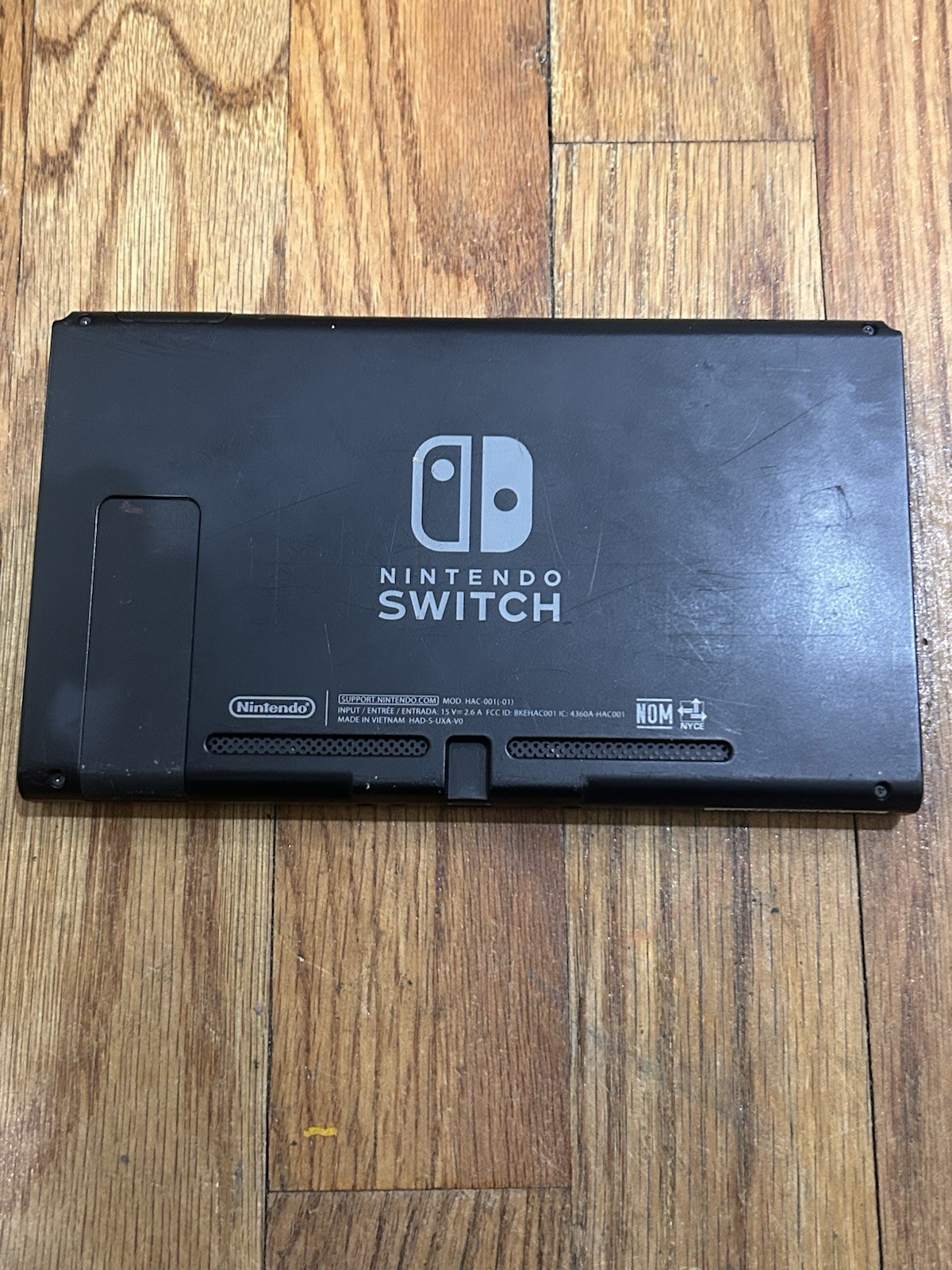 Nintendo Switch with joycon controllers, a charger, 4 games, and a game case.