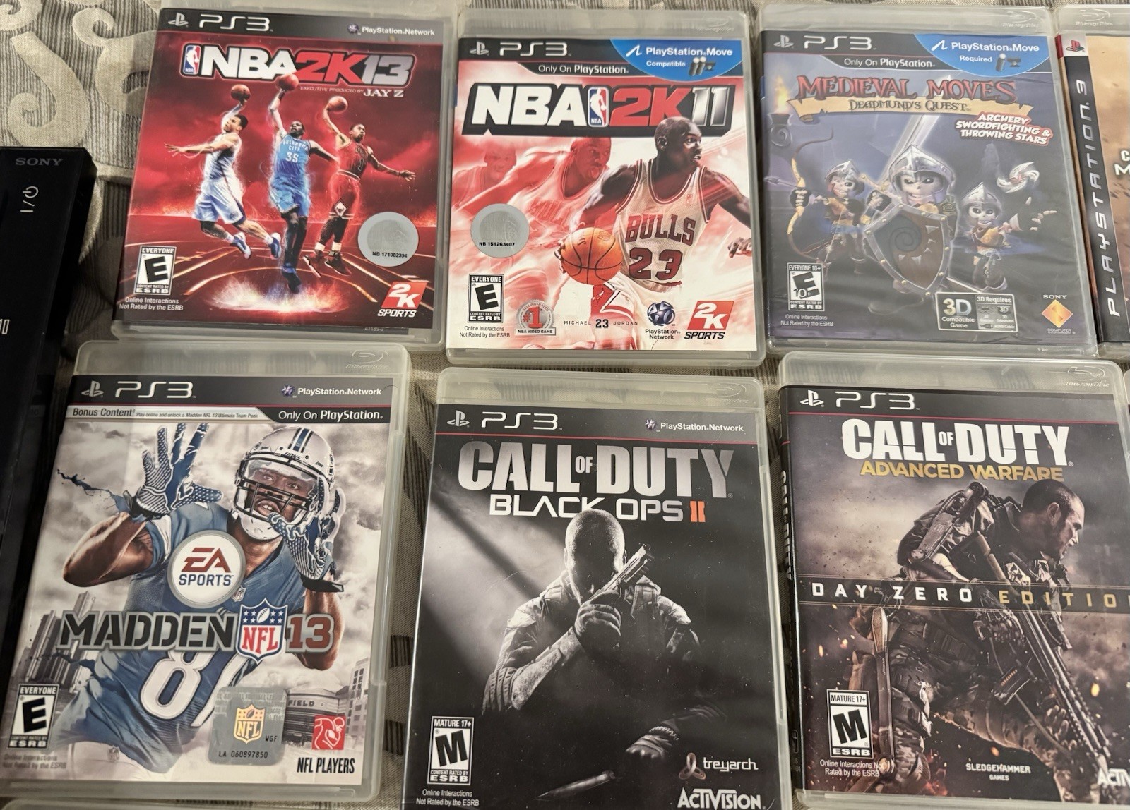 PlayStation 3 Console, Remotes, and 12 game Bundle